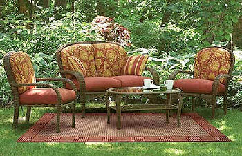 A patio set with red cushions and a coffee table.