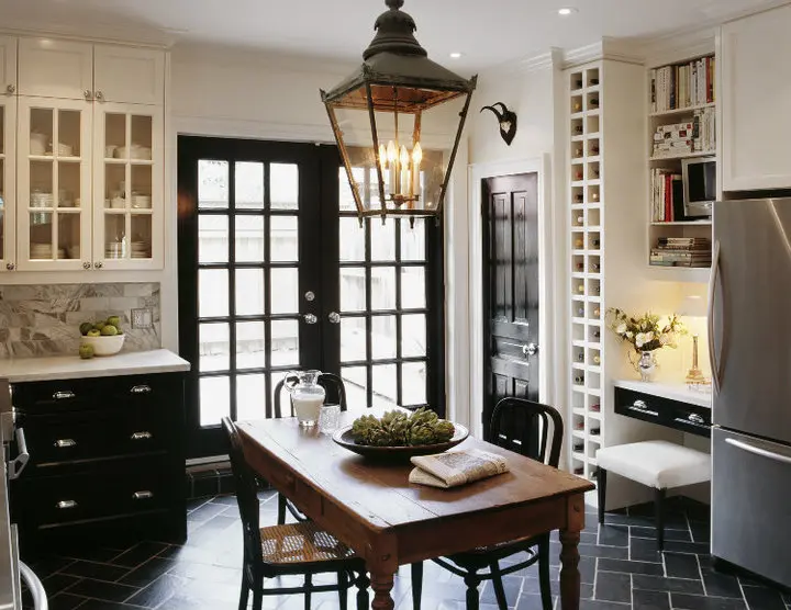 A kitchen with a table and chairs, and a lantern light.